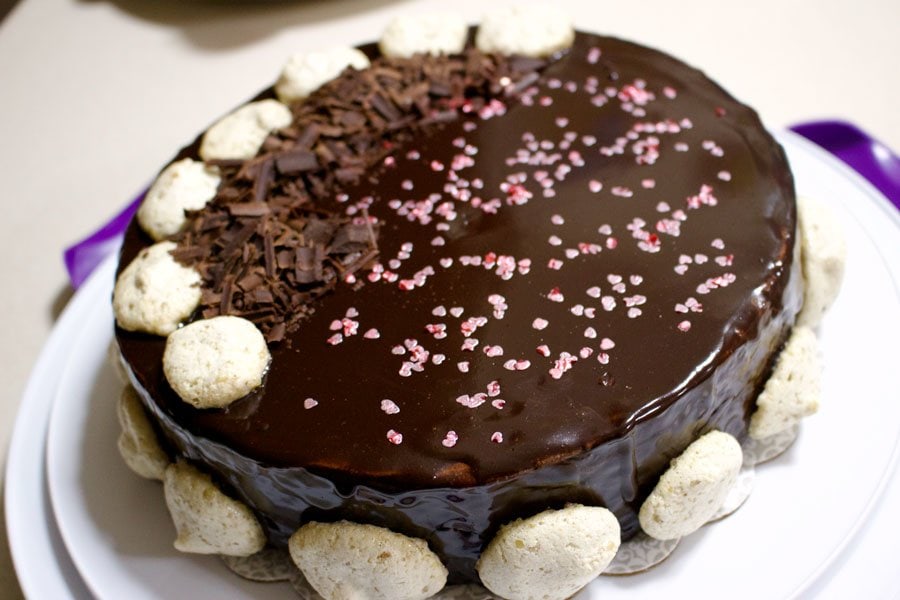 Walnut Meringue Cake With Dark Chocolate Mousse Decorated Walnut Meringue Cake WithChocolate Mousse on a whitee cake stand