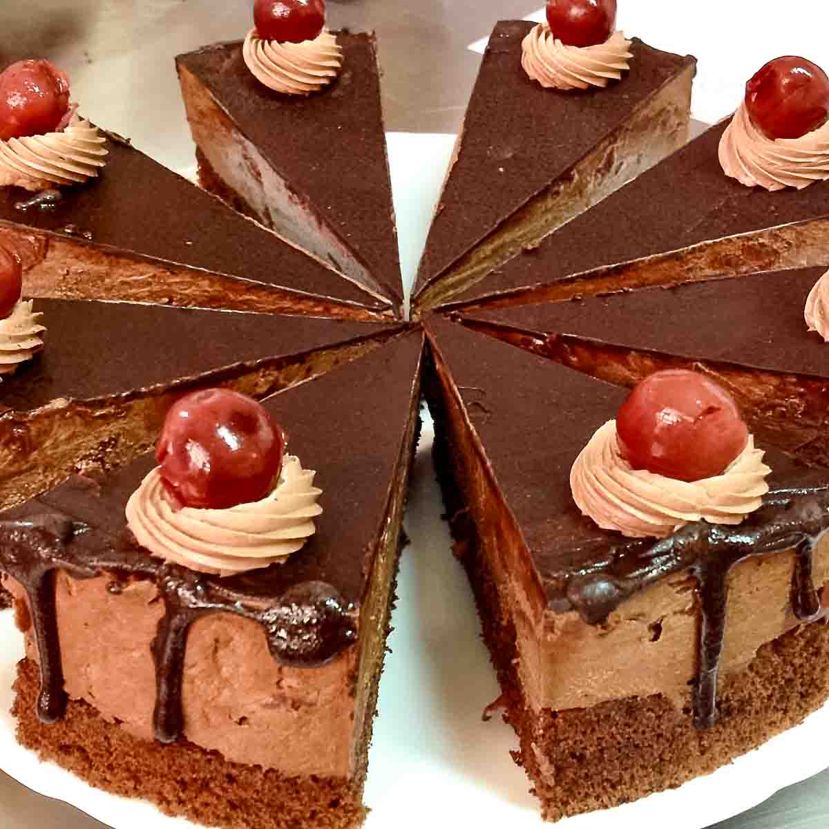 Chocolate Cake With Sour Cherries sliced on a platter.