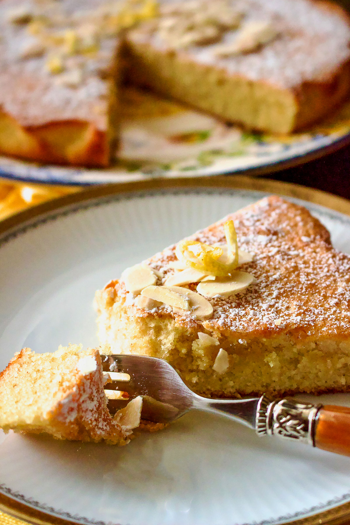 Spanish Almond Cake Recipe Tarta de Santiago44 1 A slice of spanish almond cake on a white plate with a fork.