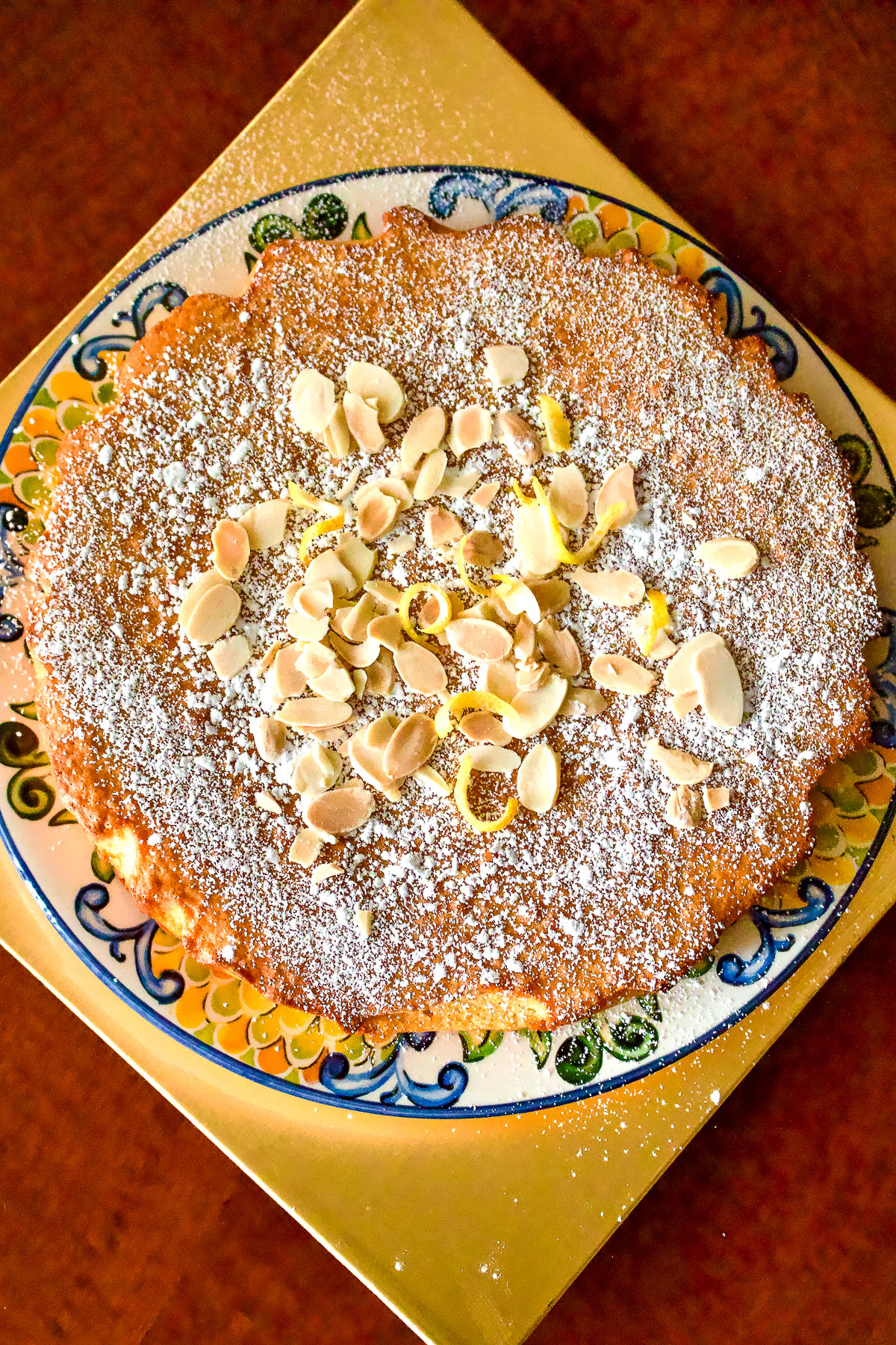 Tarta de Santiago decorated with almond slices and powdered sugar.