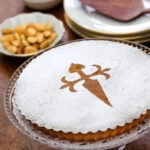 A tarta de Santiago or Spanish almond cake on a platter on the table.