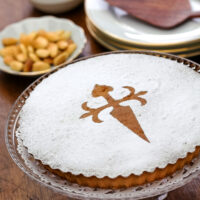 A tarta de Santiago or Spanish almond cake on a platter on the table.