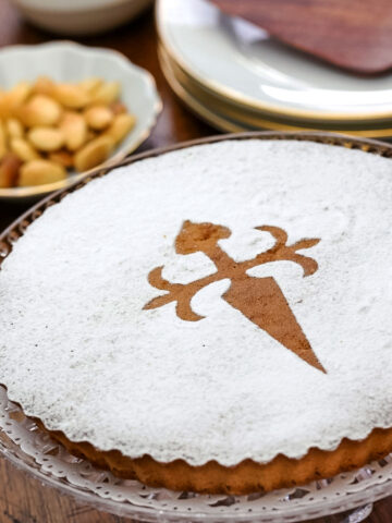 A tarta de Santiago or Spanish almond cake on a platter on the table.