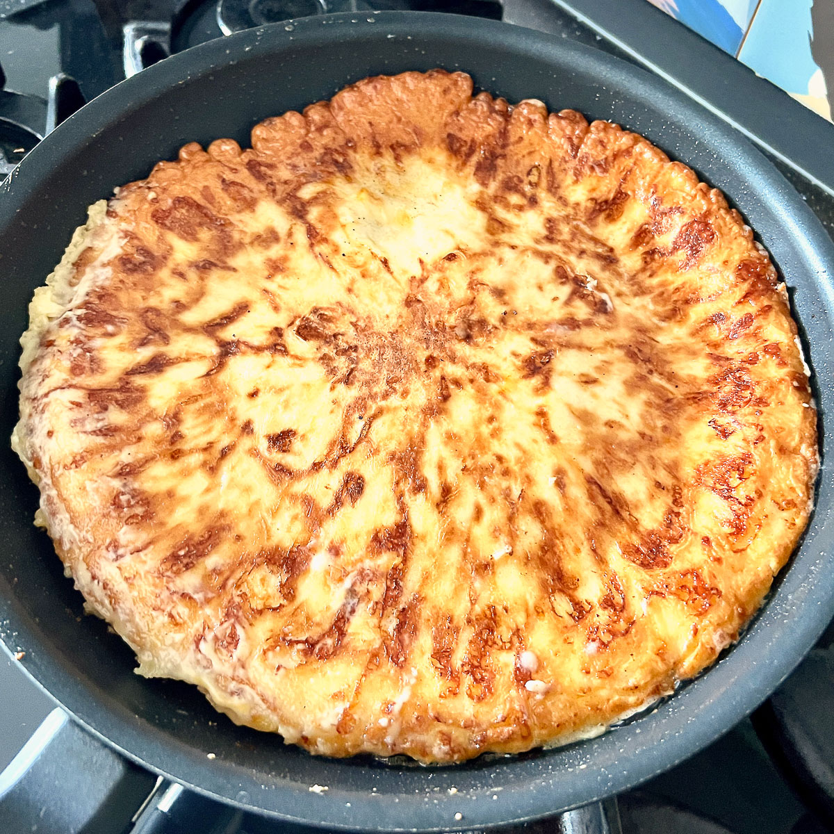 Cooking the cheese pie on the other side