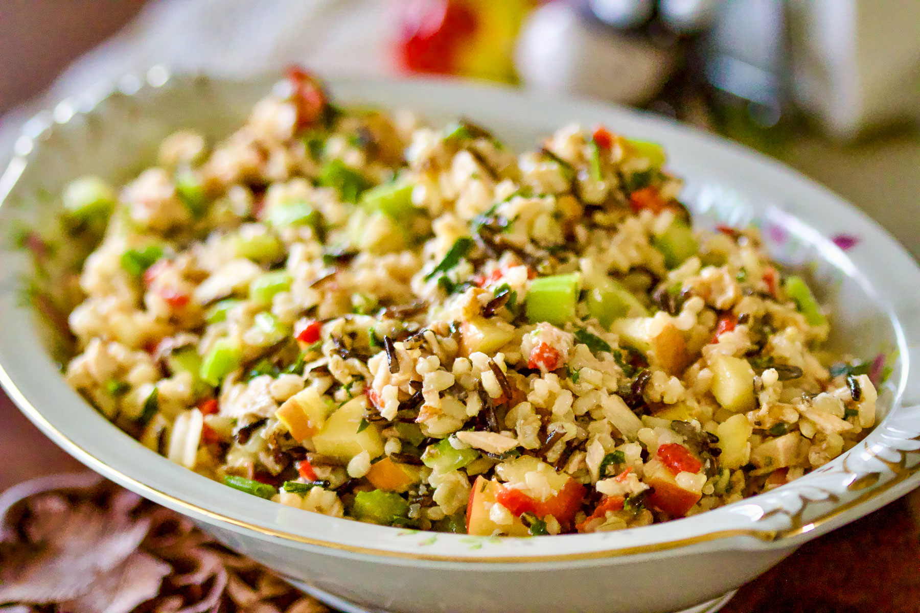 Rice salad with apples and chicken in a serving platter.