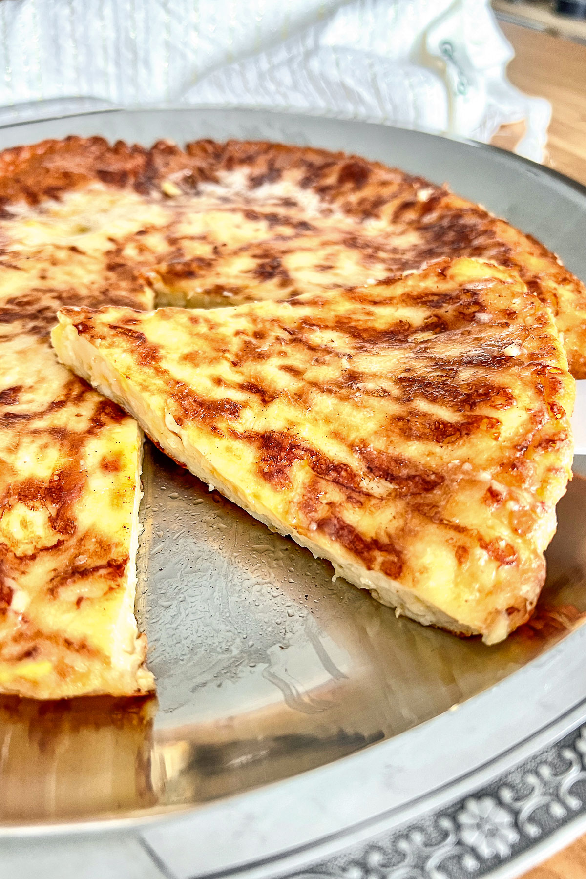 Sliced Cheese pie on a platter close up0