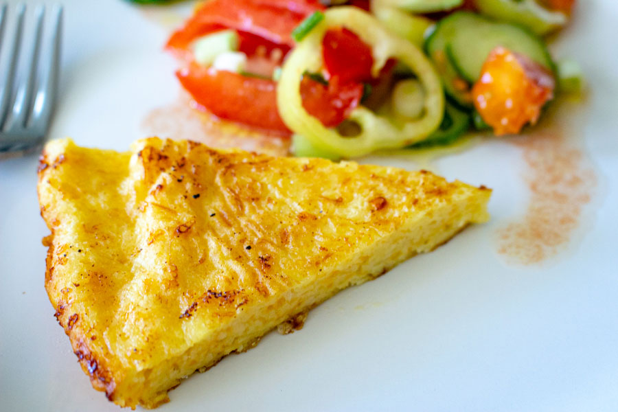 Quick And Easy Savory Cheese Pie sliced and served with tomato and cucumber salad