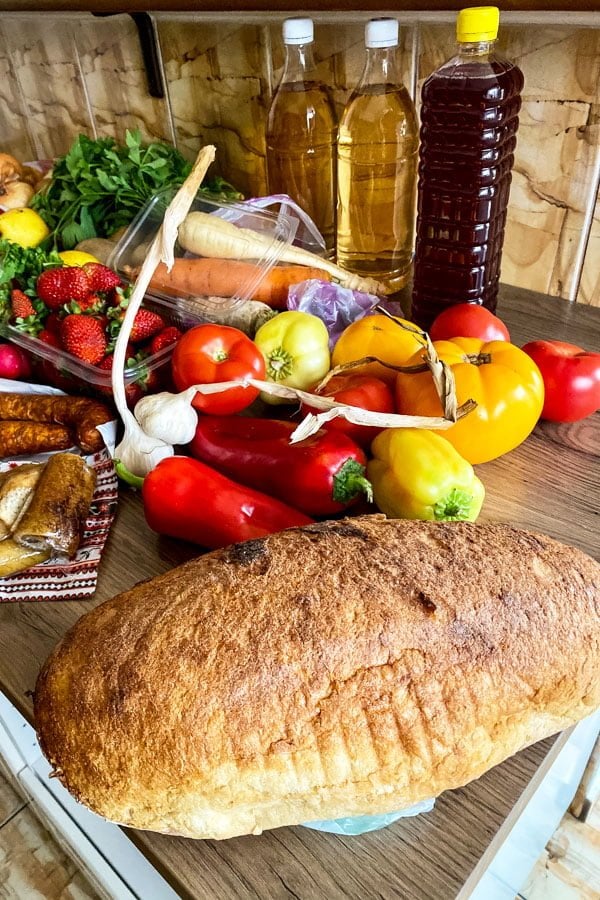 farmers market vegetables and bread sitting on the table