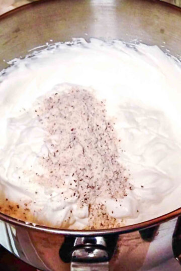 Adding almond flour to the egg whites.