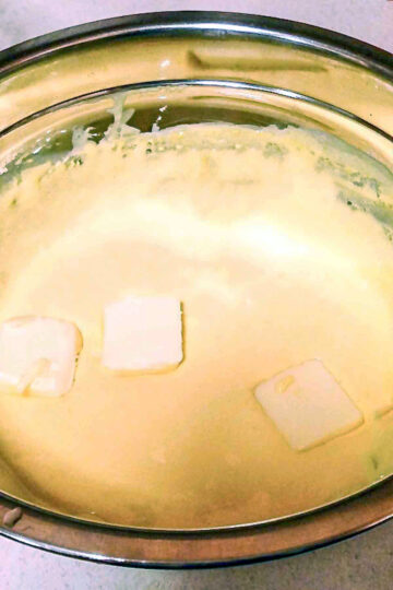 Adding butter to the French Buttercream.