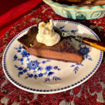 Slice of chocolate tart on blue and white plate-close up square picture