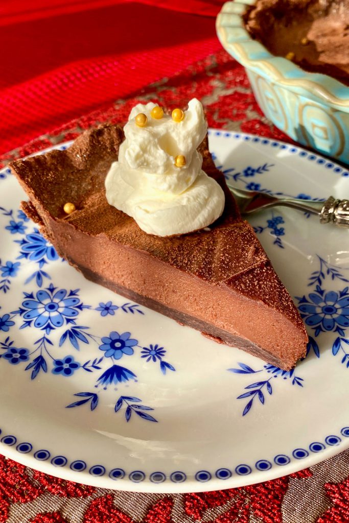 slice of chocolate tart with whipped cream on top