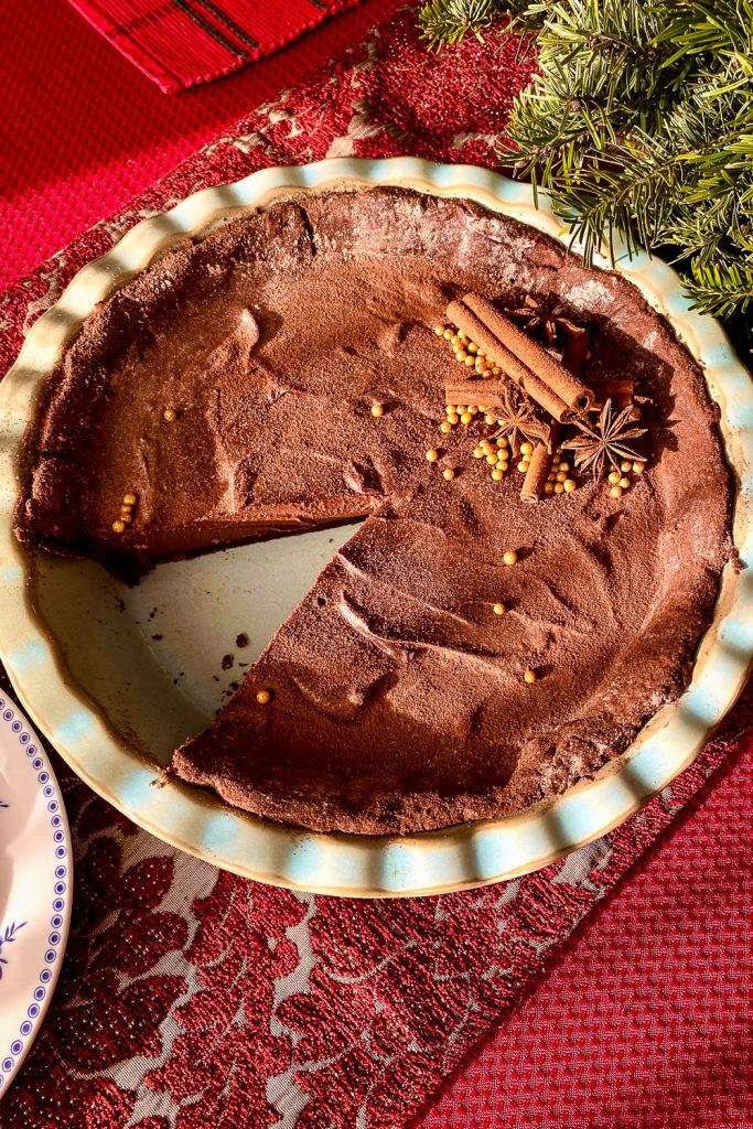 CHOCOLATE TART WITH STAR ANISE AND CINNAMON- on red tablecloth