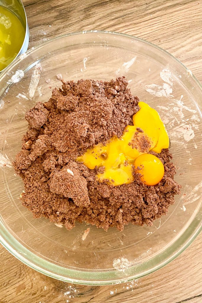 making the crust- adding eggs to the flour and butter mixture