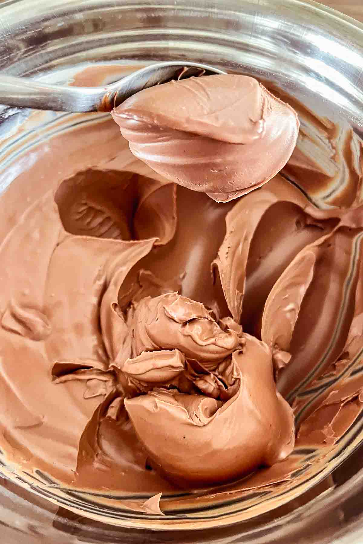 Creamy chocolate ganache in a mixing bowl.