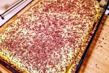 Decorating the cake with shaved chocolate.
