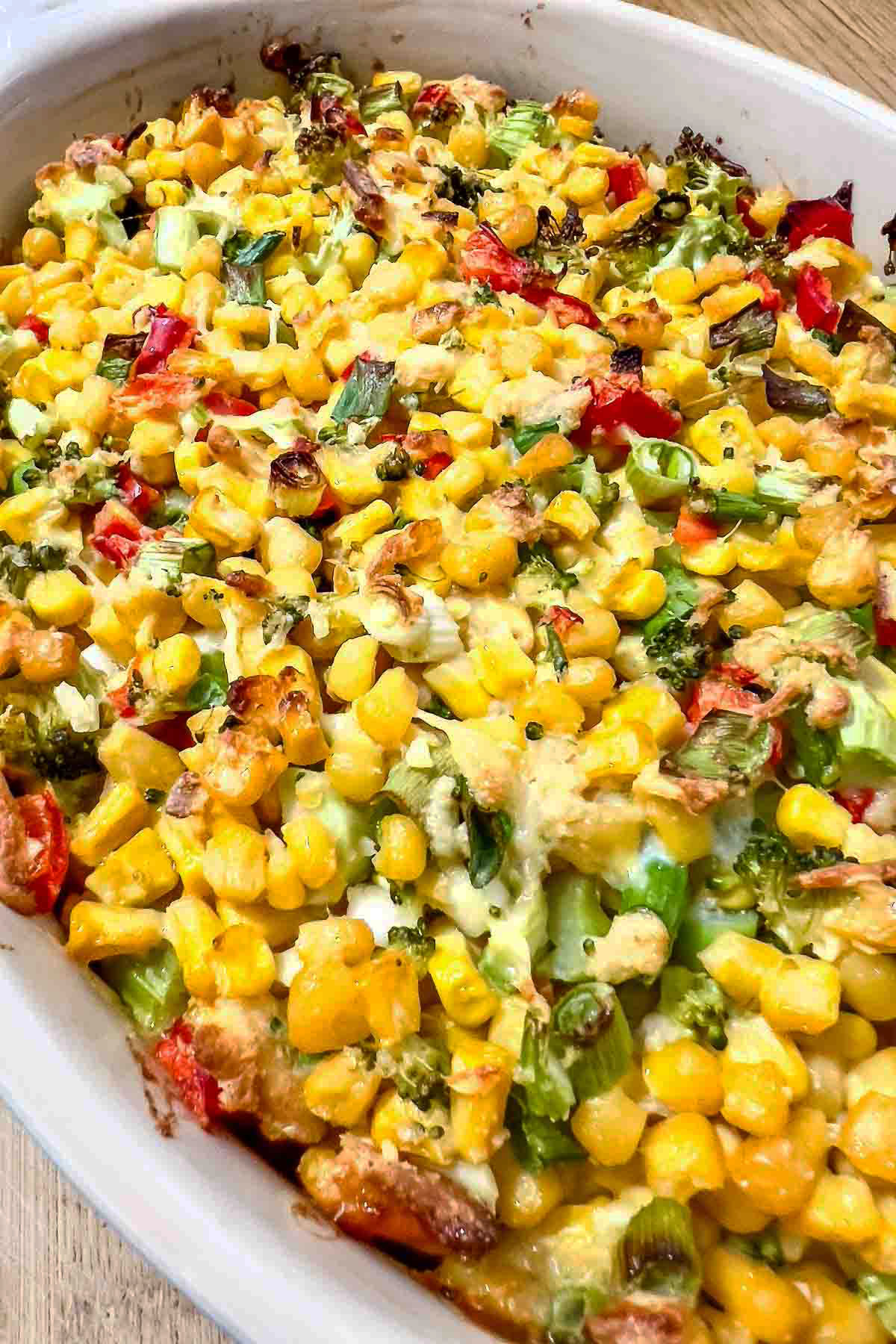 Scalloped Corn Casserole in a white baking dish.