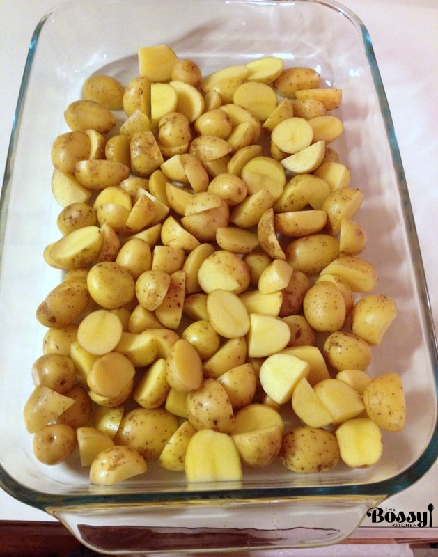 An easy simple roasted potatoes recipe, perfect for every time of the day. Also, this is a good alternative to the mashed potatoes during holidays. Raw potatoes getting ready for roasting- in a glass pan