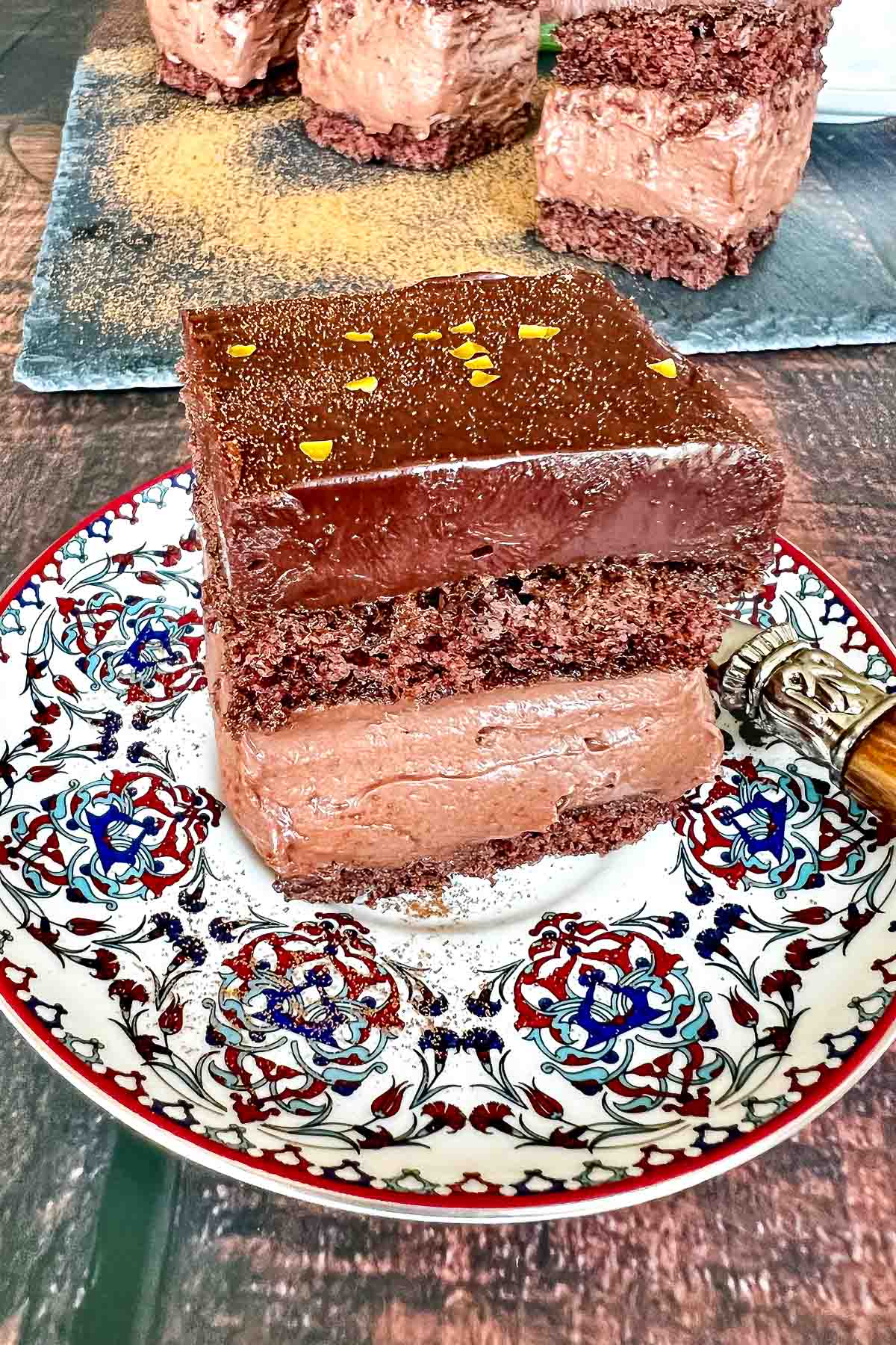 Hungarian Decadent Chocolate Cake- inspired from the original recipe of Rigo Jancsi Cake, an elegant dessert from 19th century in Austro Hungarian Empire. Slice of Rigo Jancsi Chocolate Cake on a dessert plate.