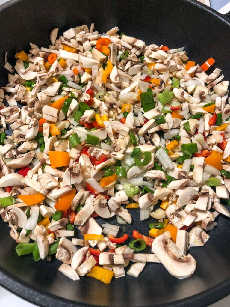 Rice pilaf with pork and vegetables is a versatile dish that can be made with your favorite vegetables. The rice pilaf in my version is either cooked on the stove or baked in the oven, which I like the best. The meat used in the pilaf is usually chicken, but pork or beef are accepted too. vegetables cooking in the pan for pilaf1