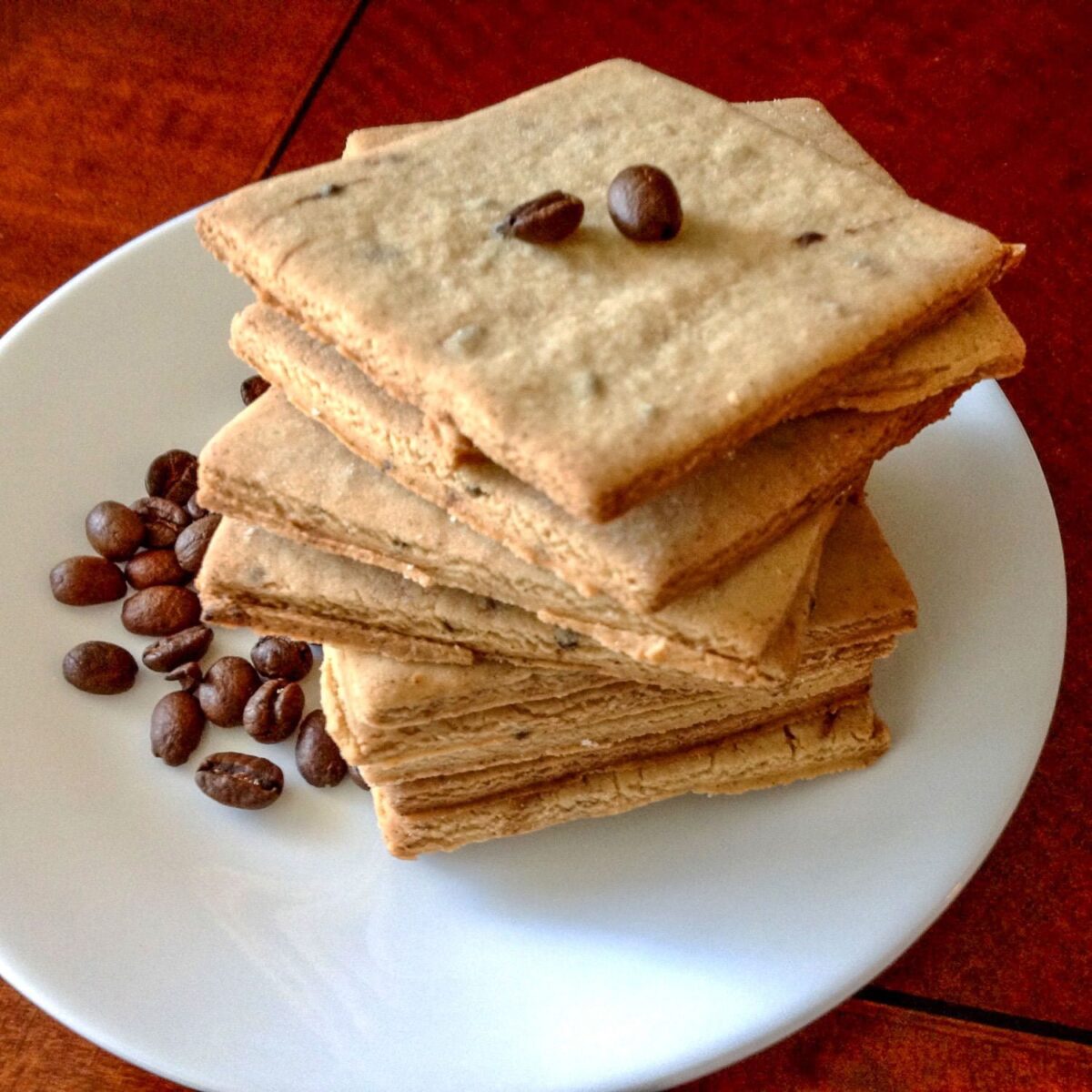 Coffee Flavored Sugar Cookies stacked on a white plate.