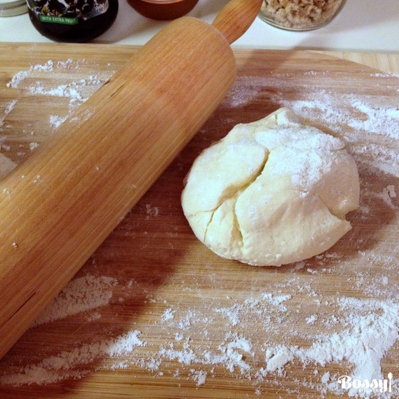 dough on a wood surface with rolling pin