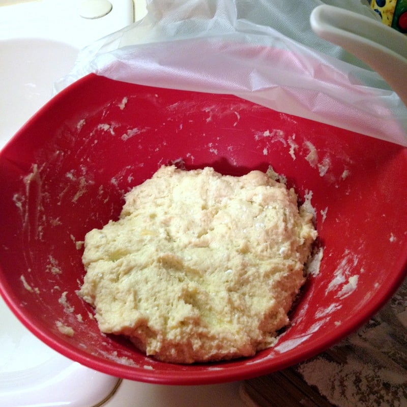 dough in a red plastic bowl