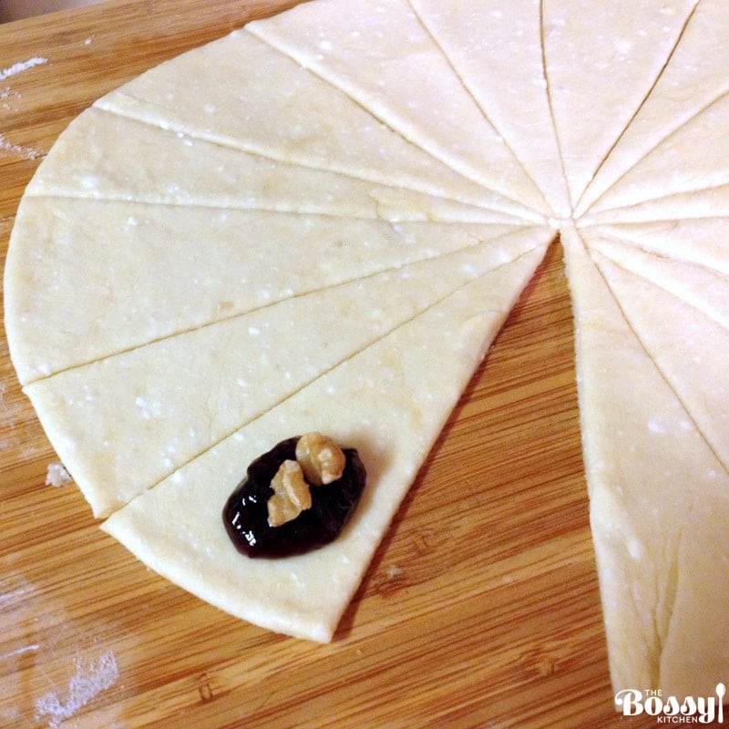 dough rolled on a wood surface for Jam and walnuts rugelach with jam and pieces of walnuts