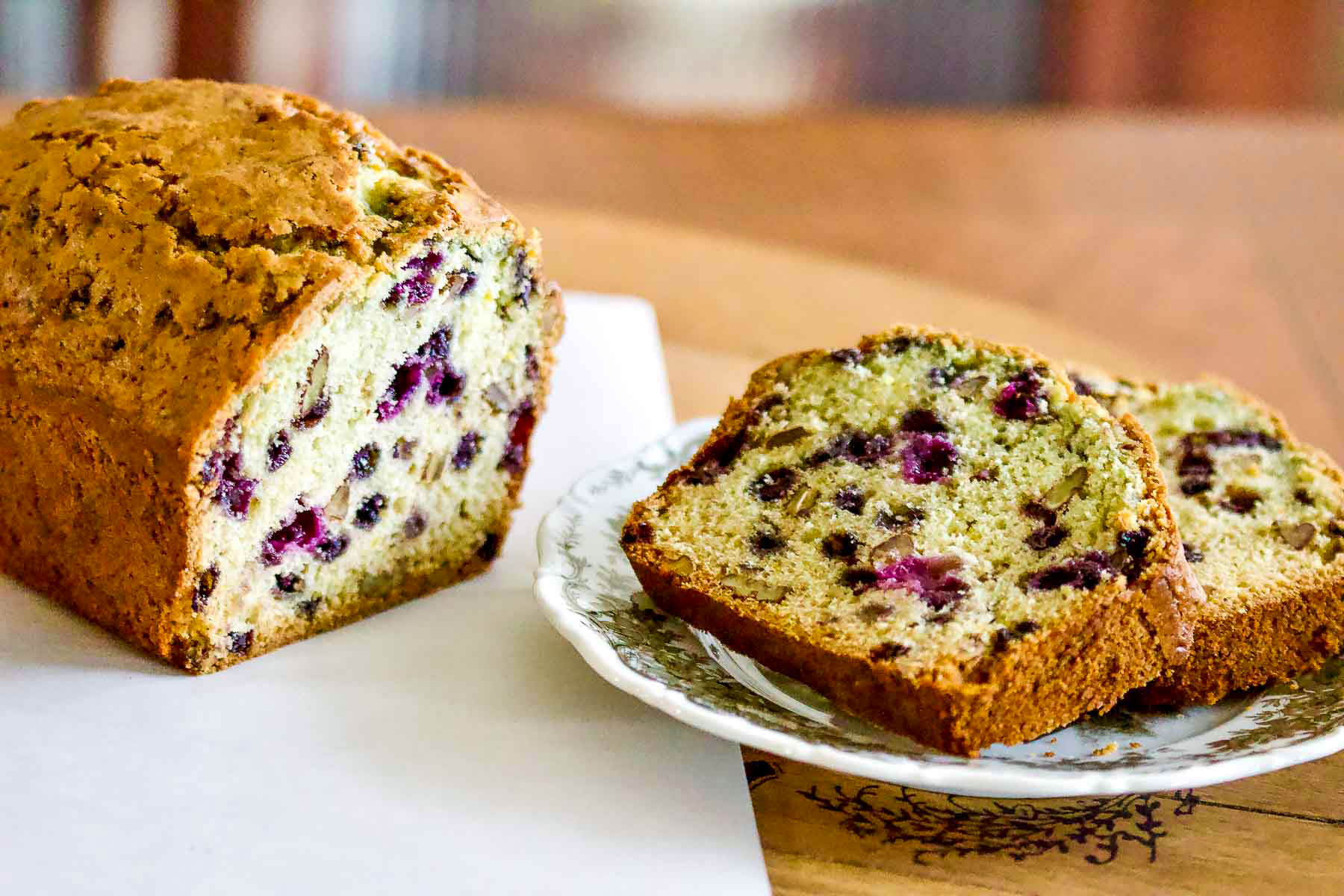 Blueberry Orange Nut Bread sliced on a plate.