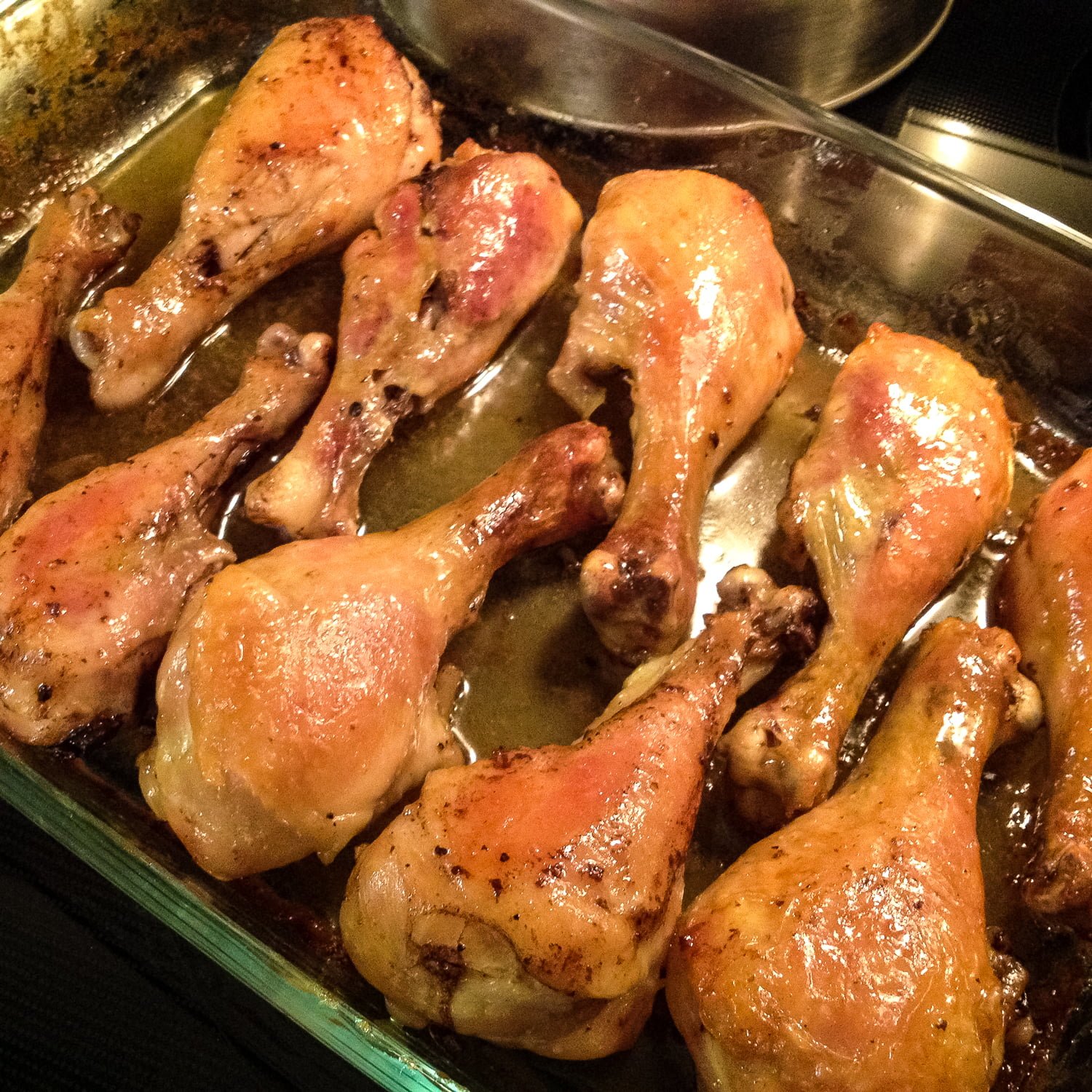 Brandy-Vanilla Butter Roasted Chicken Drumsticks- Fascinating recipe and so unusual! Delicious chicken drumsticks that are moist, perfumed and perfect for a fancy dinner. Brandy-Vanilla Butter Roasted Chicken Drumsticks in a baking pan