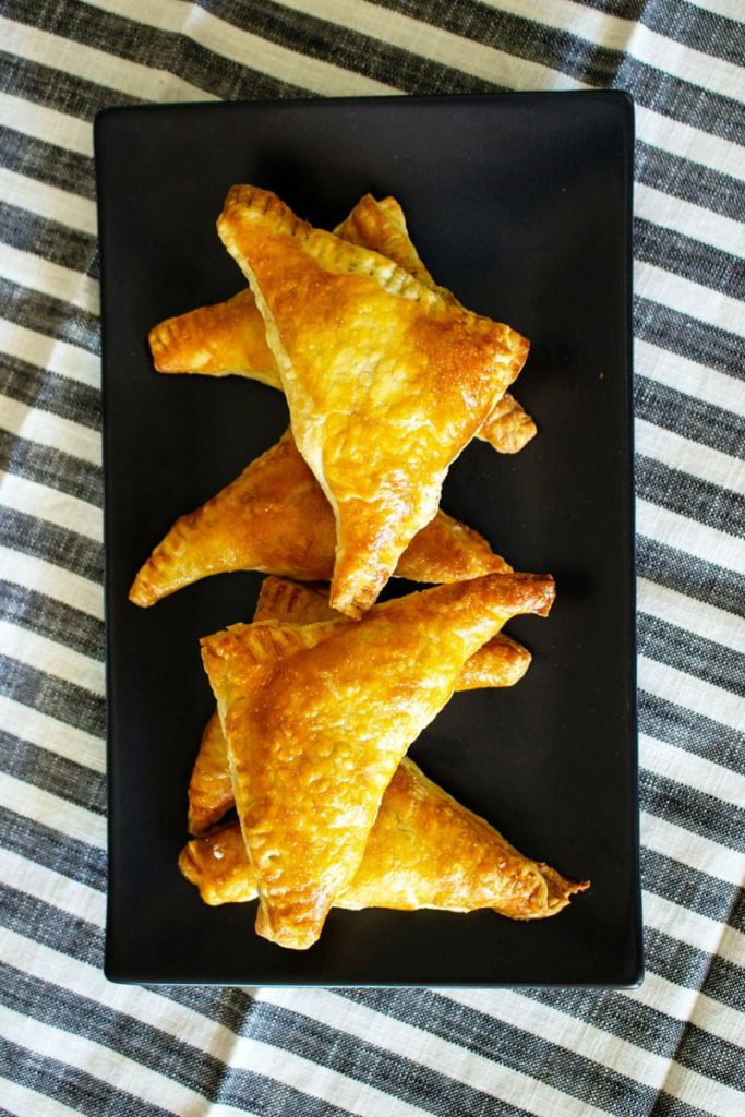 Cabbage Puff Pastry triangles on a black plate