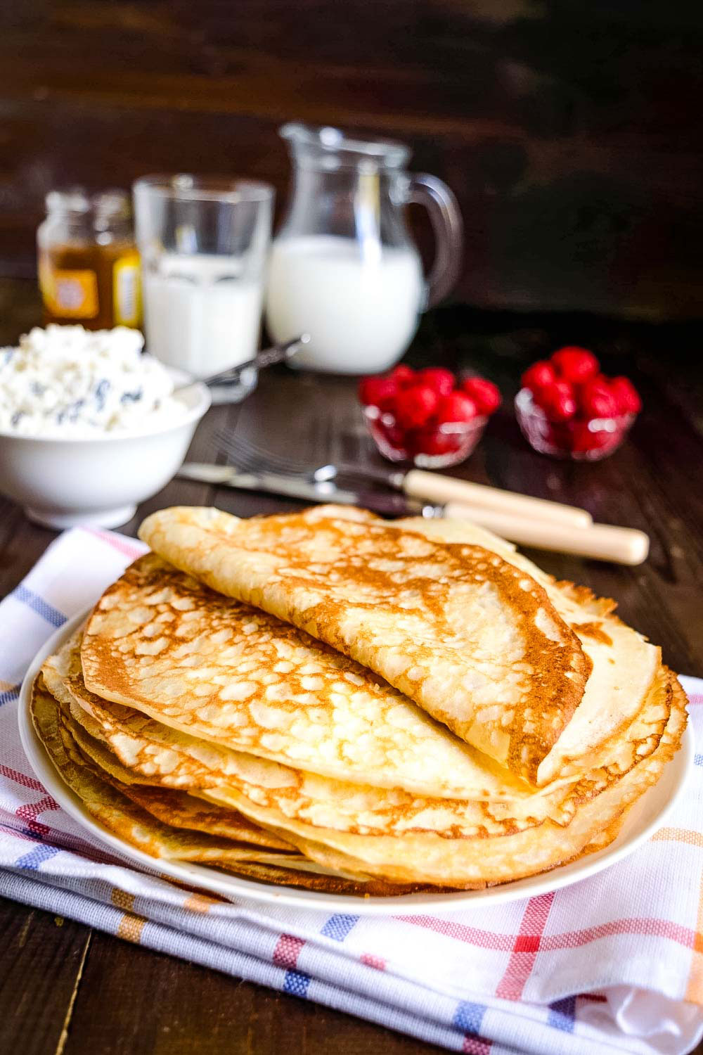 Crepes stacked on a plate.