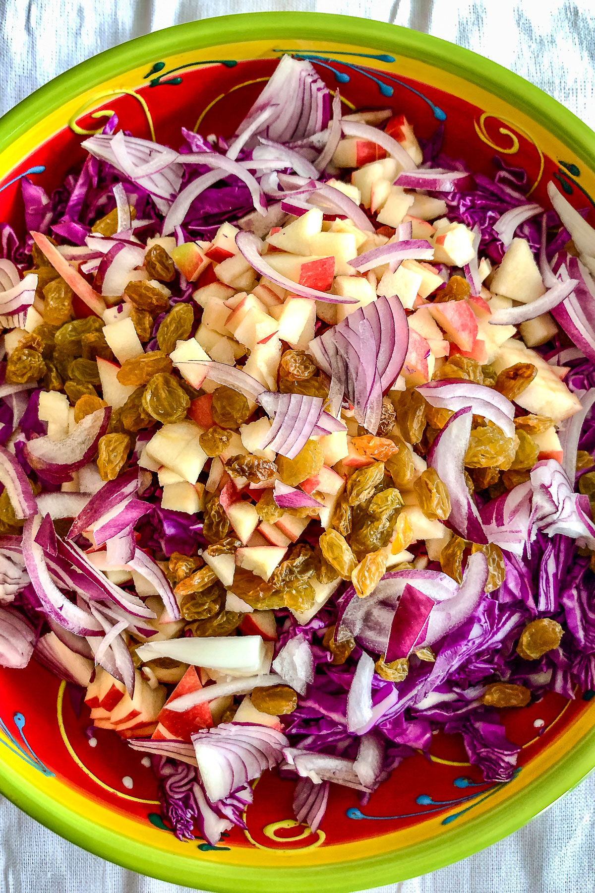 Apple Walnuts And Raisins Red Cabbage Salad0 Ingredients for red cabbage with apples and walnuts in a bowl0