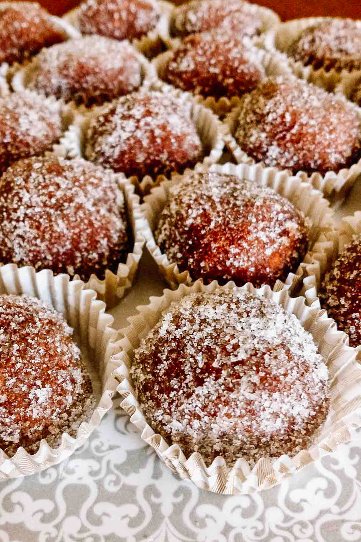 Rum balls in paper candy liners.