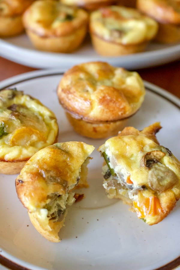 This Easy Vegetarian Mini Quiche Recipe can be served as breakfast, brunch or appetizer. Looks beautiful and it is also a good option for vegetarians. Mini quiche on a white plate