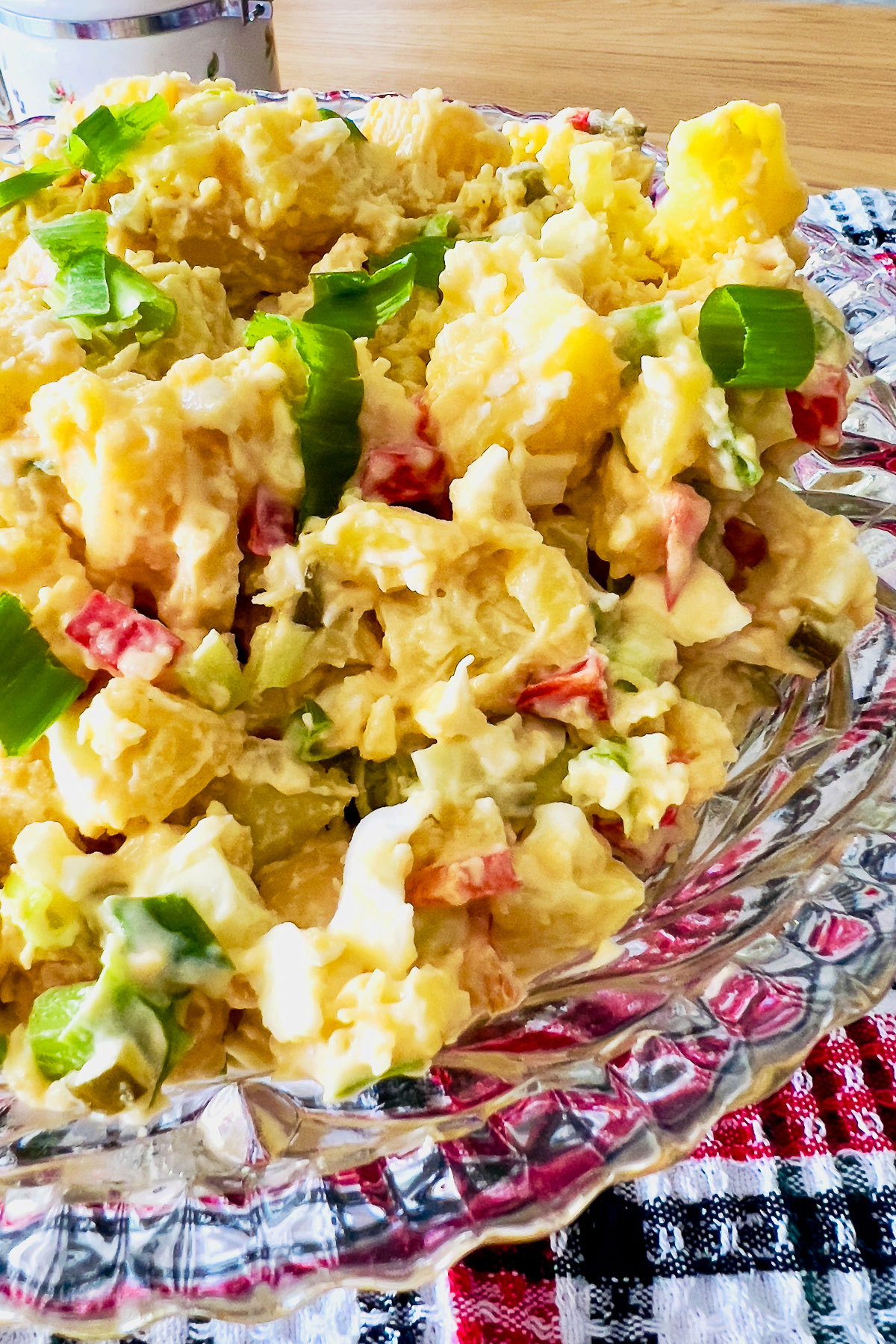 This is a classic, delicious easy American potato salad that can be made all year round. Make it with a day before and serve it chilled. Classic Potato Salad in a glass bowl