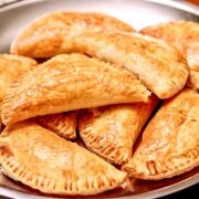 Ham and Cheese Pastries Stacked on a metal tray.