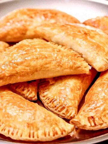 Ham and Cheese Pastries Stacked on a metal tray.