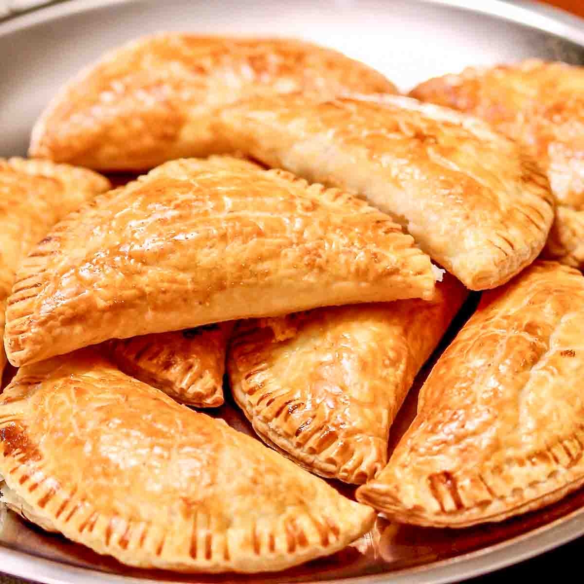 Ham and Cheese Pastries Stacked on a metal tray.