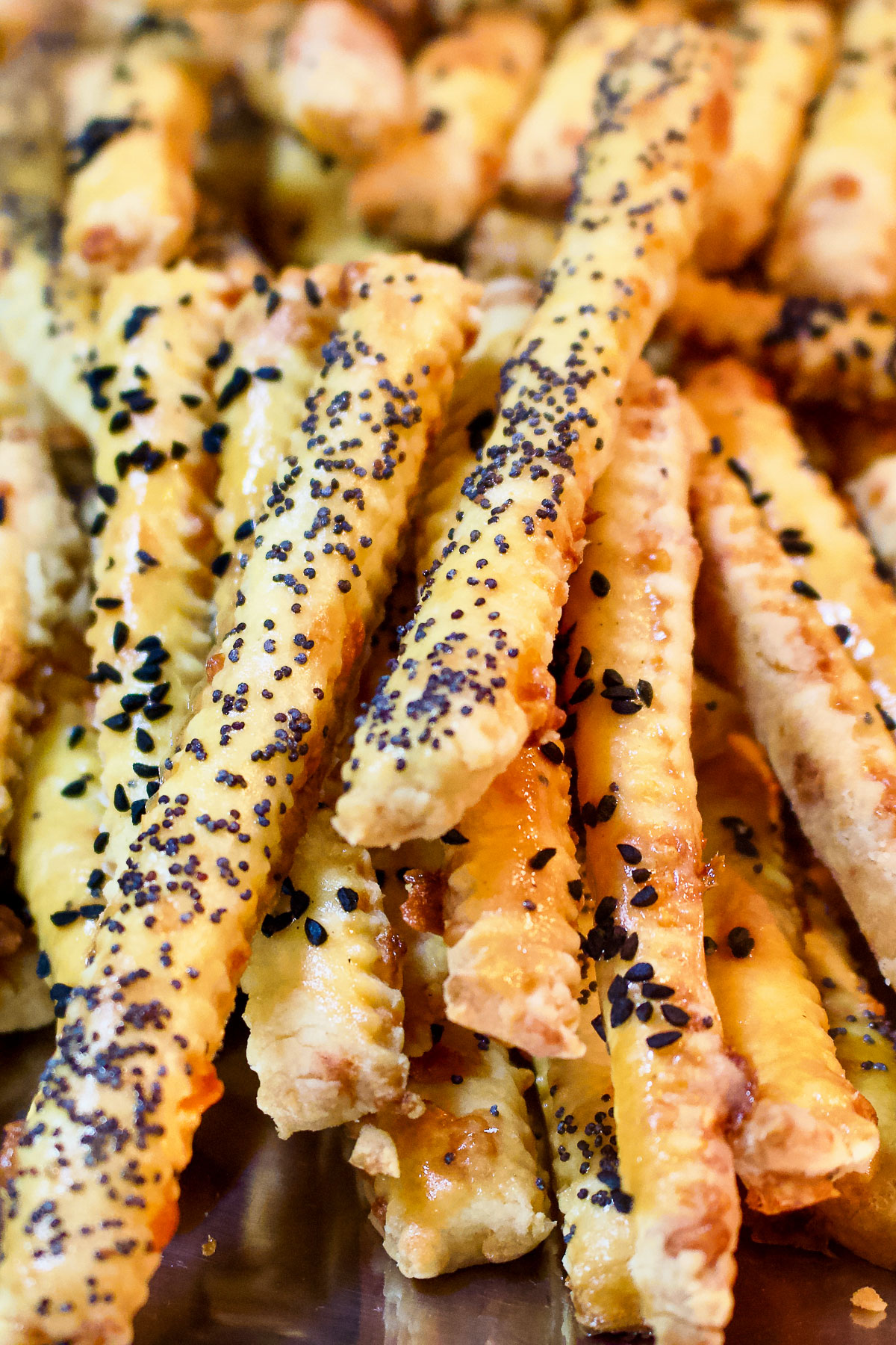 cheddar cheese straws with black caraway seeds Cheddar Cheese Straws vertical image