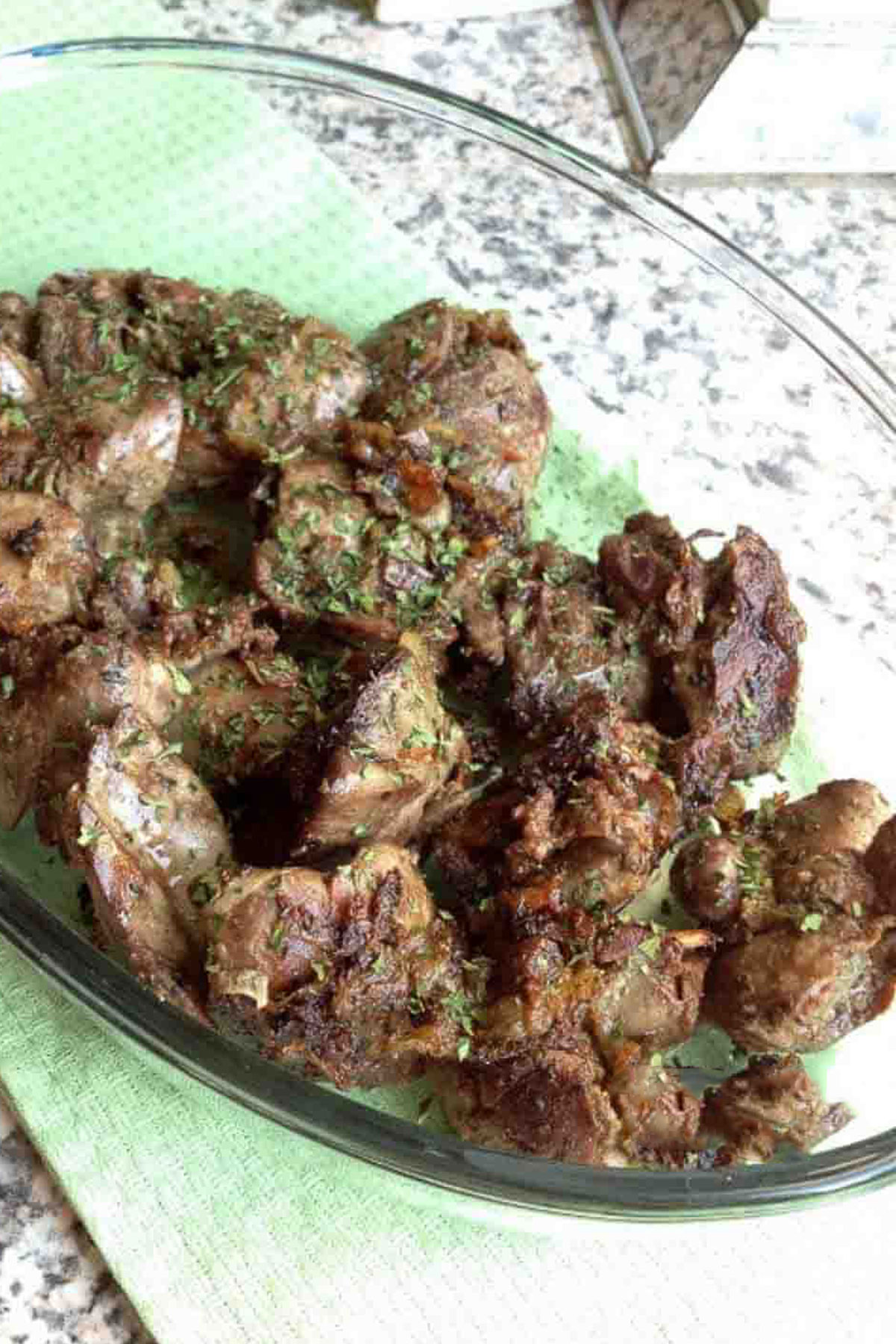 Cooked Chicken Livers With Caramelized Onions in a glass platter.