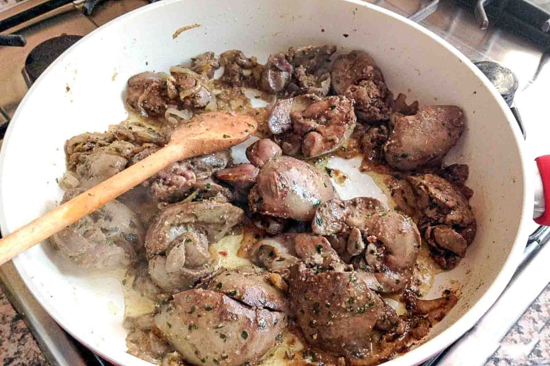 Cooked Chicken Livers with onions in the skillet.