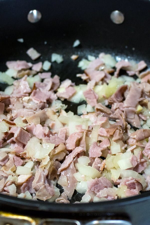 Easy Green Peas With Ham- Spanish recipe- is an easy dish that can be made in no time using fresh or frozen peas. For authenticity, use jamon Serrano. onion, garlic and ham cooking together in the pan