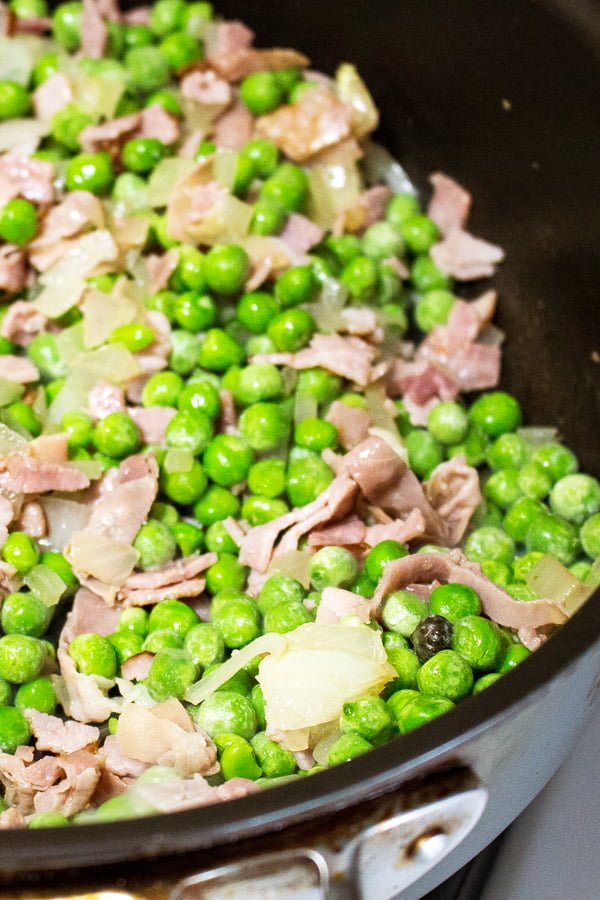 Easy Green Peas With Ham- Spanish recipe- is an easy dish that can be made in no time using fresh or frozen peas. For authenticity, use jamon Serrano. Easy Green Peas With Ham- Spanish recipe- is an easy dish that can be made in no time using fresh or frozen peas. For authenticity, use jamon Serrano.
