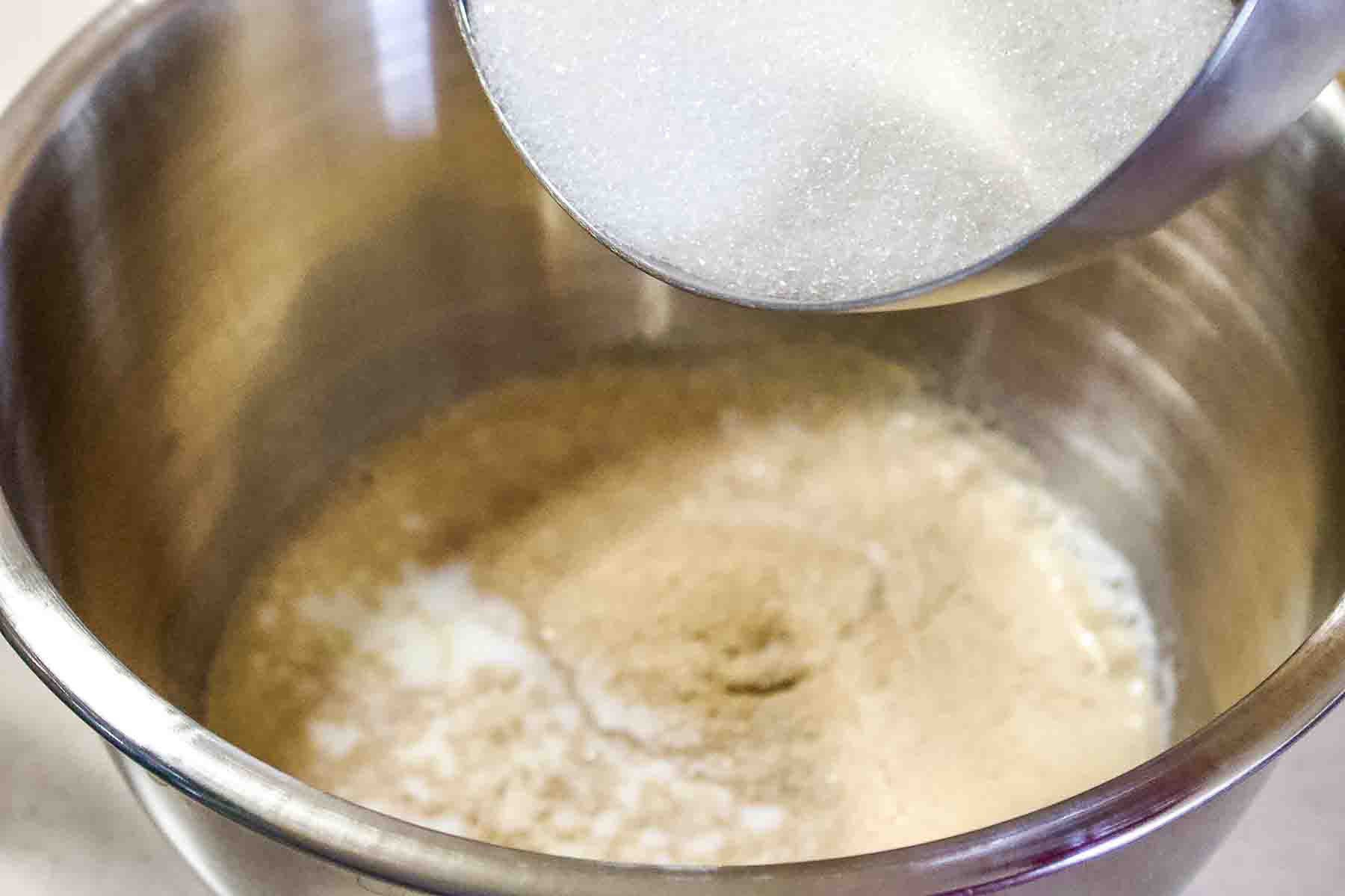 Milk with yeast and sugar in a bowl.