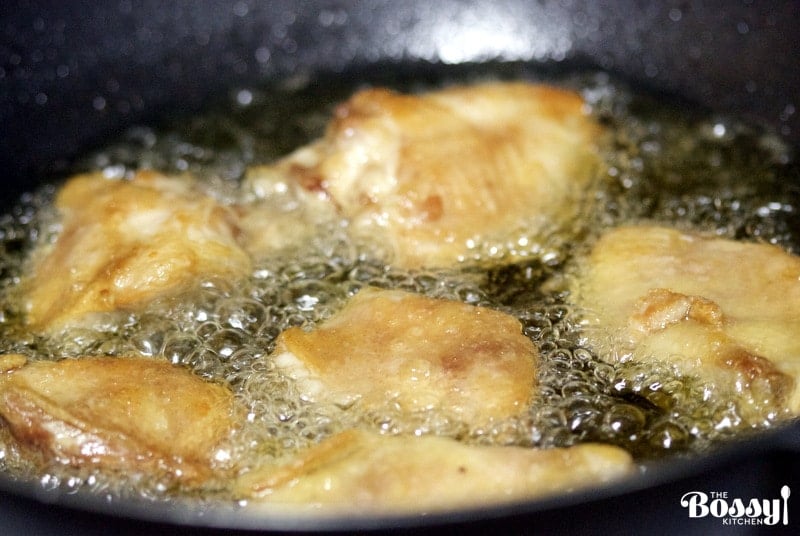 Easy No breaded fried chicken thighs frying in a pan