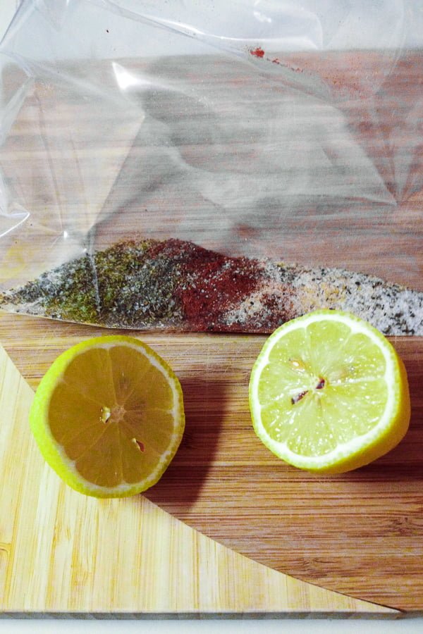 Roasted Lemon Chicken Drumsticks Recipe101 spices in a ziploc bag and lemons
