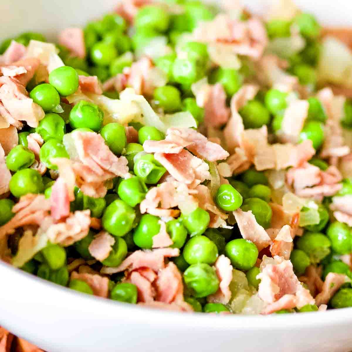 Spanish Peas with Ham in a white bowl.