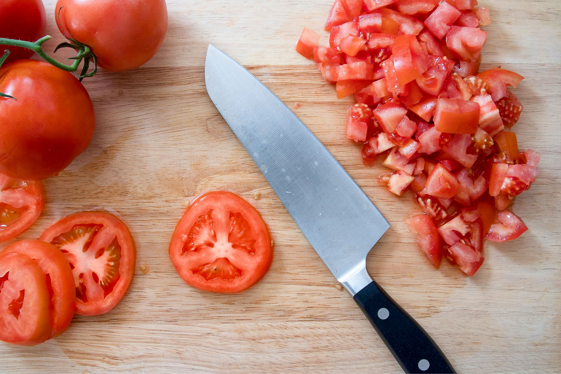 Chopped tomatoes on wooden board