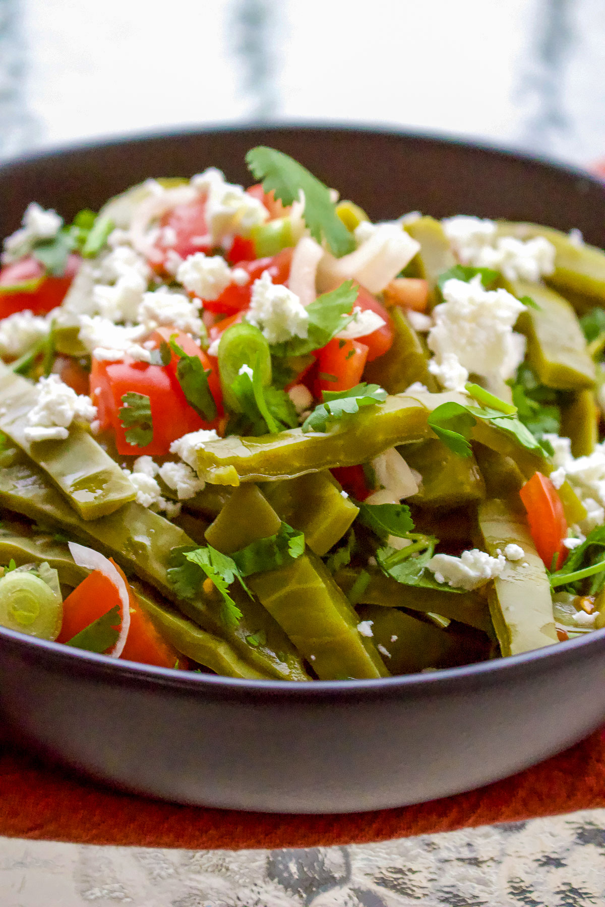 Ensalada de nopales with crumbled cheese on top